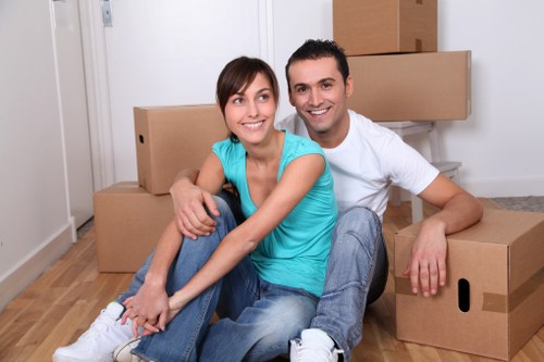 Professional movers handling furniture in a Hendon property
