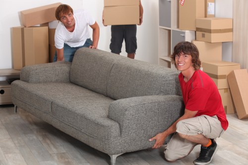 Removal professionals carrying office equipment through a building