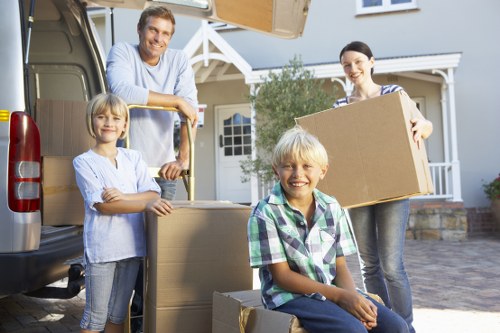 Movers carrying furniture through a Hendon flat access area